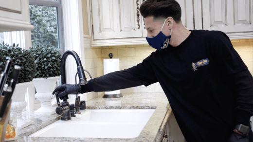 Man Turning off sink